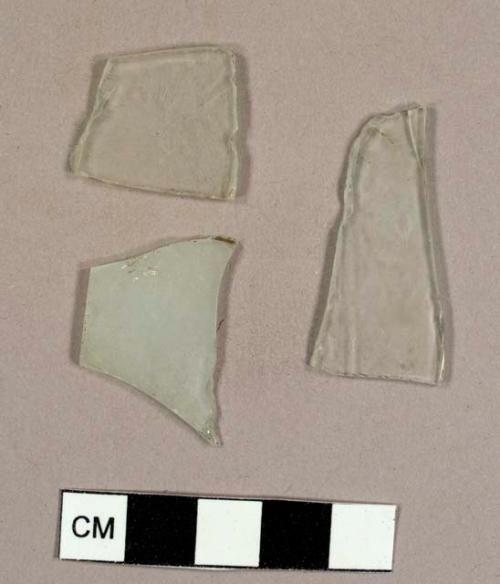 Colorless flat glass fragments, some frosted