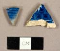 Ceramic sherds, one ironstone with blue transfer print and one grey, salt glazed stoneware with blue glaze on the exterior