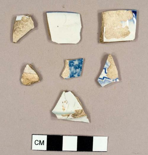 Pearlware sherds, including two blue feather-edged plate rim sherds, one plain plate base, and one plain plate rim