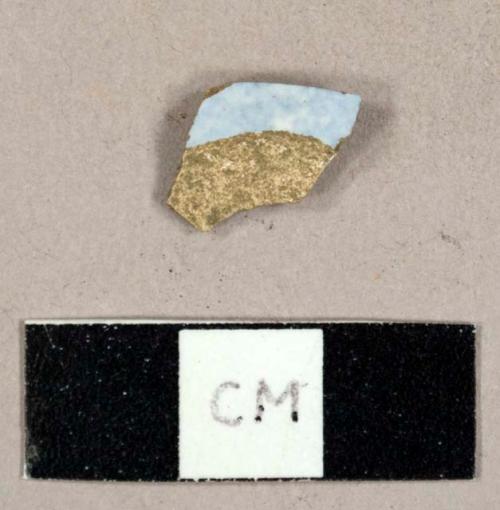 Whiteware sherd with blue transfer print or sponge pattern on exterior