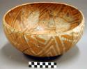 Ceramic bowl, bown on red interior, white on red exterior, mended