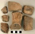 Ceramic, earthenware body and handle sherds, undecorated, shell-tempered; two handle sherds crossmend; two body sherds crossmend