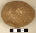 Ground stone, worked flat disc