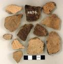 Coarse earthenware body and rim sherds, some cord impressed, some incised; non-cultural stone fragment