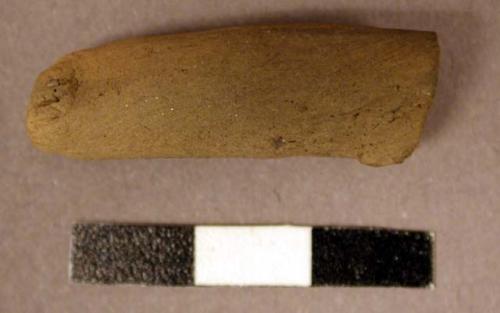 Possible human figurine. broken at one end. ressembles leg--cylindrical rod with