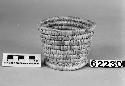 Small, cylindrical basket from the collection of J. Daniels, 1902. Close-coiled.