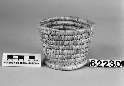 Small, cylindrical basket from the collection of J. Daniels, 1902. Close-coiled.