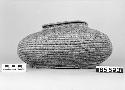 Lidded, elliptical basket from the collection of G. Nicholson. Close coiled.