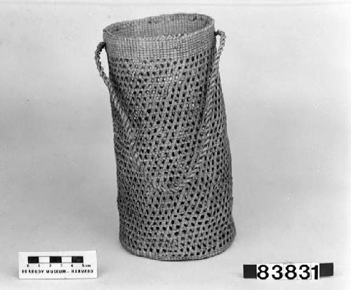 Cylindrical basket with cord handle from the collection of Lt. Woodworth, ca.1878. Plain, open-twined; crossed warps.