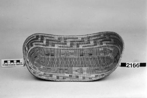 Oblong tray/mat from the collection of E.G. Fast, 1867-8. Plain twined, false embroidery.