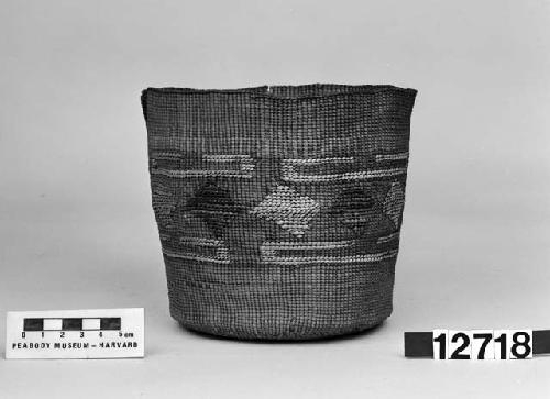 Cylindrical basket from the collection of the brothers of Mrs. J.M. Robinson, 1883-1925. Plain twined, false embroidery.