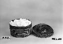 Trinket basket with rattle lid from the collection of the father of F.H. Curtiss. Plain twined, false embroidery.