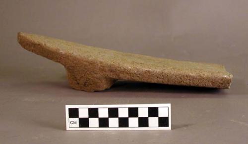 Ground stone metate fragment, base of broken off leg