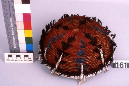 Bowl-shaped baskets, covered on outside with feathers of buff and green in a che