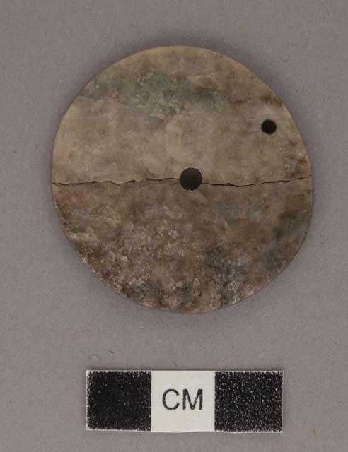 Perforated jadeite disk