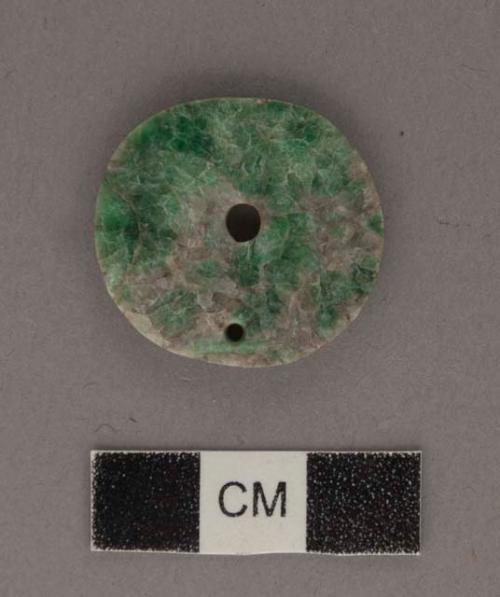 Perforated jadeite disk