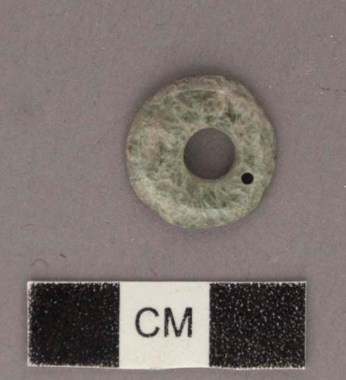 Perforated jadeite disk