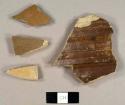 Stoneware sherds, three buff-bodied with brown glaze on interior and clear salt-glaze on exterior, one grey-bodied with tan glaze on exterior, possibly from a ginger beer bottle