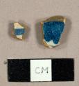 Tin-glazed earthenware sherds, one with buff body, one with pink body, both with handpainted blue decoration