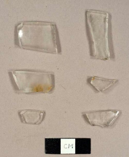 Colorless curved glass fragments, including two rims to possible cups