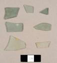 Assorted flat glass fragments, including two colorless and five aqua fragments