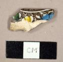 Earthenware, refined, whiteware; brown transferprinted,  green, yellow, and blue hand painting, body sherd