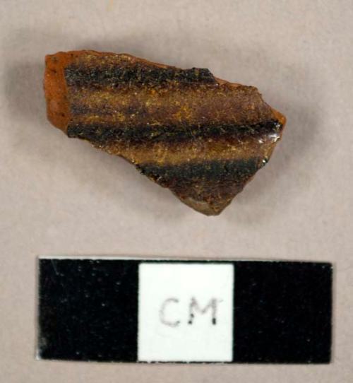 Lead glazed refined redware sherd with ribbing on exterior