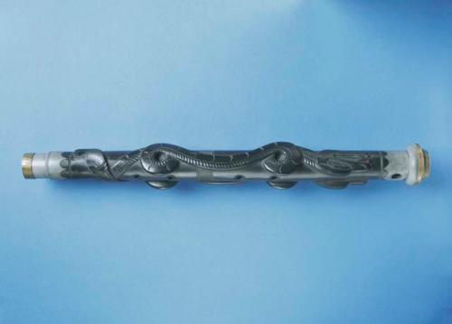 Musical instrument made of carved argillite, flute shaped