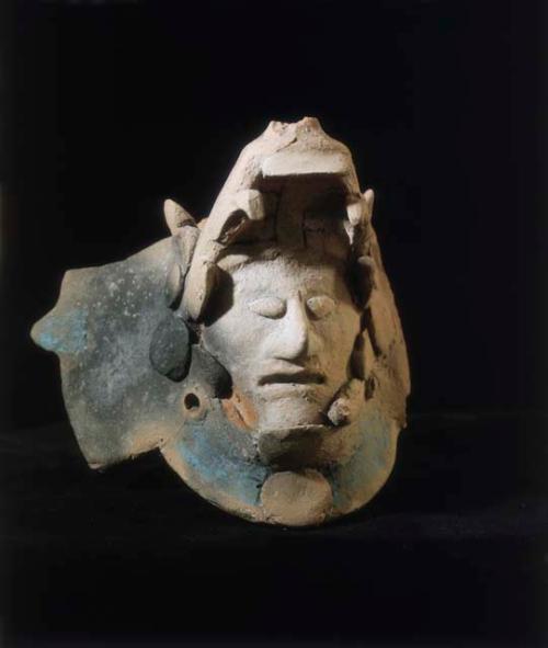 Human head in jaw of serpent (fragment)