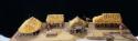Diorama. Overall view of 4 thatched, open-sided dwellings, etc.