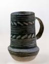 Cylindrical mug, black on white geometric design on exterior