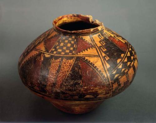 Payupki polychrome pot. [Style A, Polychrome-on-Orange]. Symmetrical and busy de