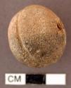 Spindle whorl. nearly spherical single perforation through center. medial groove
