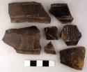 Ceramic sherds, black finish, incised decoration, some repaired