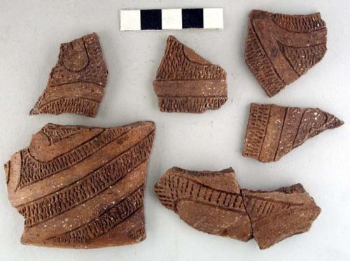 Ceramic sherds, rim/body, incised and punctate striated design, repaired