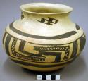 Fine geometric black-on-yellow pottery jar