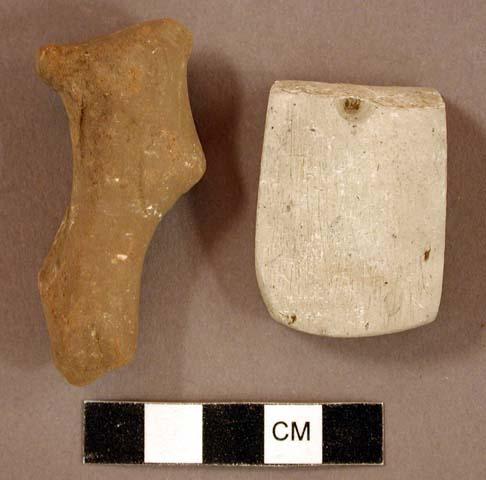 Ground stone, pecked and ground stone fragment, partially perforated; worked stone object