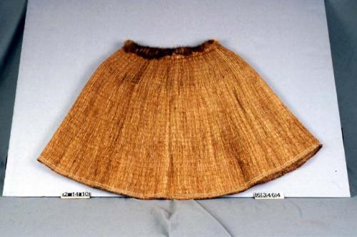 Shredded cedar bark cape. Circular. Worn by both sexes.
