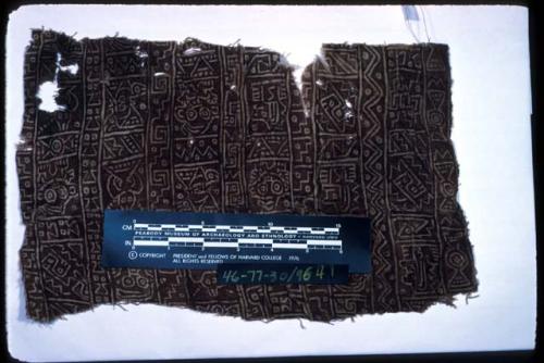 Organic, painted textile fragment with geometric designs