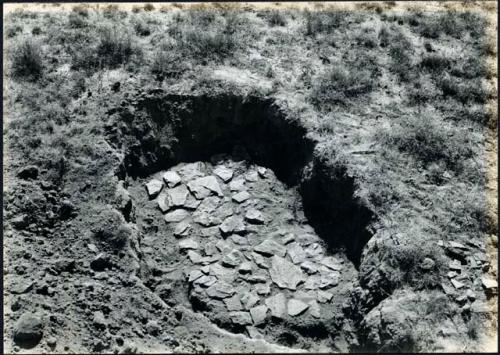 Scan of photograph from Judge Burt Cosgrove photo album. Oct. Nov 1933 Pendleton Ruin Stone platform west side of plaza in east house.