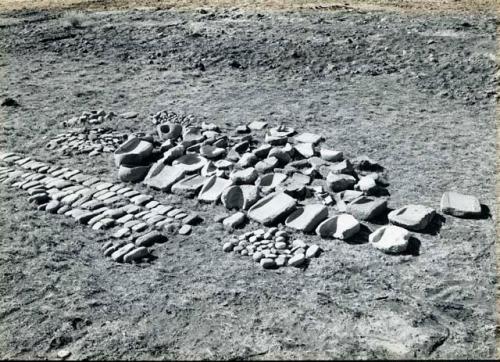 Scan of photograph from Judge Burt Cosgrove photo album. Pendleton Ruin. Manos,rubbing, stones, metates and mortor.