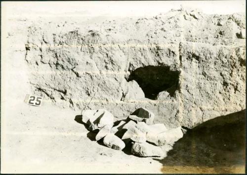 Scan of photograph from Judge Burt Cosgrove photo album. October-November 1933. Pendleton Ruin. Rocks and broken metates taken out of doorway.