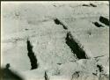 Scan of photograph from Judge Burt Cosgrove photo album. October-November 1933. Pendleton Ruin. Stone flags below adobe floor of Room 17 to make it rat proof.
