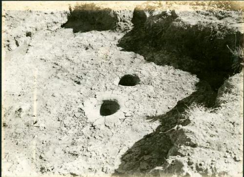 Scan of photograph from Judge Burt Cosgrove photo album. October-November 1933. Pendleton Ruin. Close up of double fire pits in Room 10.