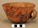 Red pottery cup with dark zig-zag designs. probably 19th c..