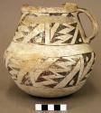 Ceramic pitcher, black on white exterior, one handle, sherds missing from rim