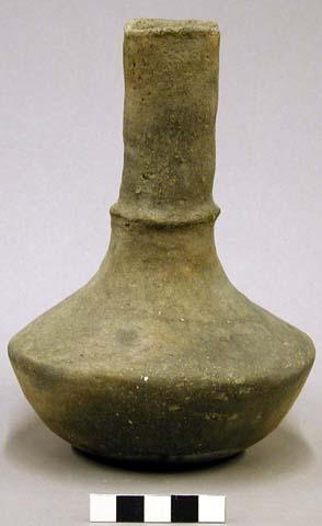 Ceramic vessel, tall neck, flared lip, fillet around neck, flattened base.