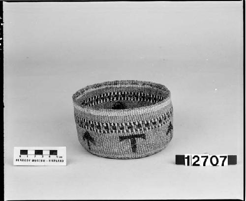 Small cylindrical basket from the collection of the brothers of Mrs. J.M. Robinson, 1883-1925. Plain twined, two-face overlay.