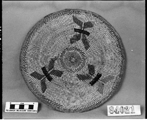 Circular mat or plaque from the collection of G. Nicholson. Plain and three-strand twined, one-face overlay.