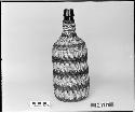 Covered bottle from the collection of the brothers of Mrs. J.M. Robinson, 1883-1925. Twined.